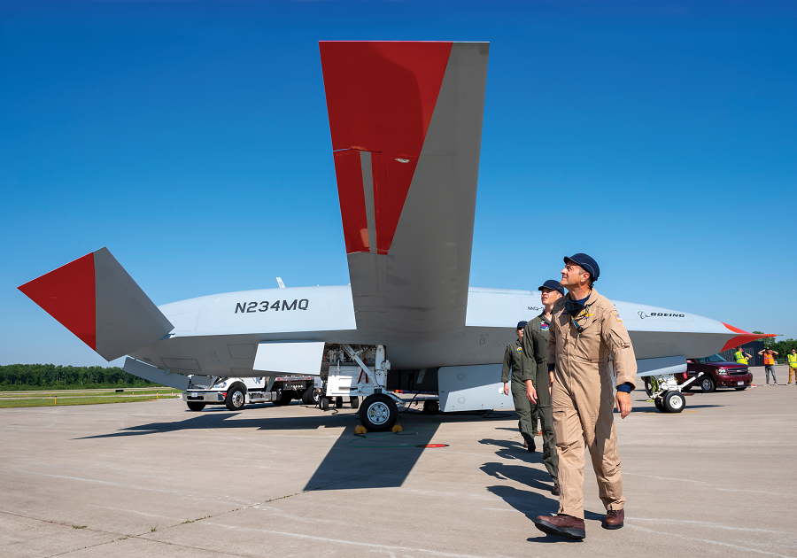 Sam Platt (foreground) is Boeing's chief test pilot for the MQ-25. He directs a team of five air vehicle operators—the personnel who plan and manage the autonomous flight of the Stingray—in support of the drone's test and development program. Here, he does a preflight inspection of T1 at Mid America Airport in Mascoutah, Illinois.