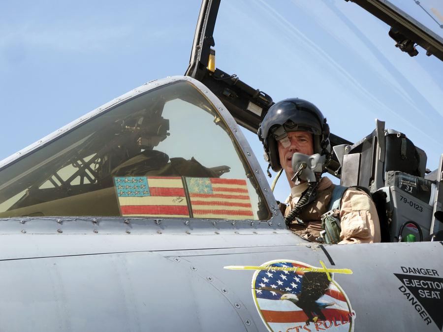 Marks in cockpit at Bagram Air Base in 2014. Marks carried American flags drawn and colored by children on the left side of his front canopy into battle with him on combat sorties from Bagram. (Photo courtesy Lt. Col. John Marks) 