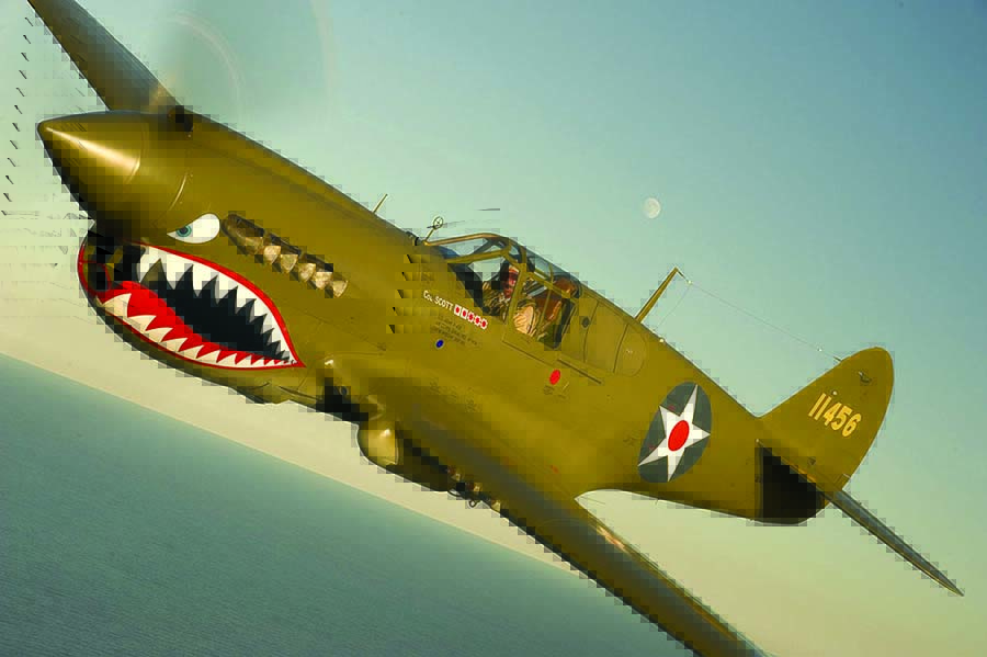 The late Bob Baranaskas flies his beloved P-40 near the Shinnecock Inlet on Long Island’s south shore. (Photo by E. Hildebrandt/flynavybook.com)