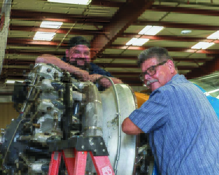 Casey and his father Frank Wright, the man who inspired his love for mechanics and warbirds, wrench on the Pratt & Whitney R-985 nine cylinder radial that powers the airplane that began the Yanks collection in 1973—a Beech UC-43 Staggerwing. (Photo by Richard Takenaga)