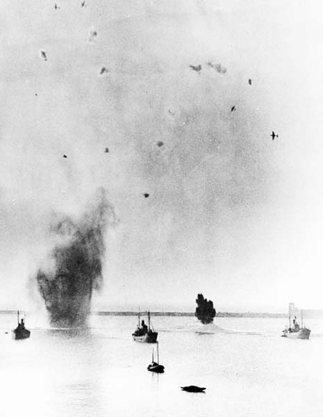 A remarkable photo taken on July 29, 1940, at Dover as the harbor was under attack by dive-bombing Ju 87 Stukas. Bombs are exploding in the water around the ships and the sky is full of bursting anti-aircraft shells and wheeling Ju 87s pulling away. (Photo author’s collection