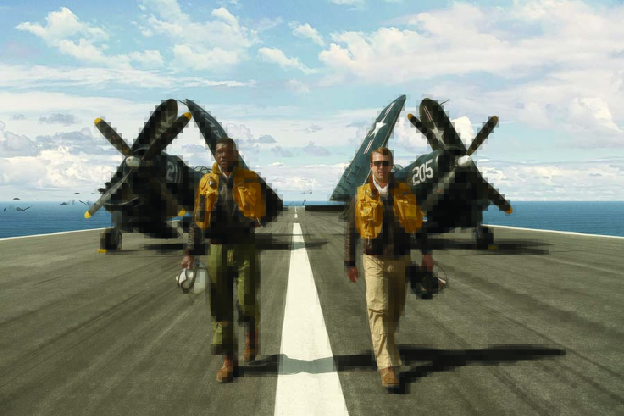 Majors (left), who plays Brown, and actor Glen Powell, who plays Thomas Hudner Jr., stride aft on the mock-up flight deck of the USS Leyte. Computer-generated imagery (CGI) was used sparingly in “Devotion.” Here’s an instance where the water surrounding the flight deck, created on one of the two runways at Bulloch County Airport, is CGI. (Photo by Eli Adé/Columbia Pictures)
